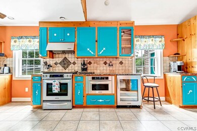 Kitchen featuring premium range hood, beverage coo