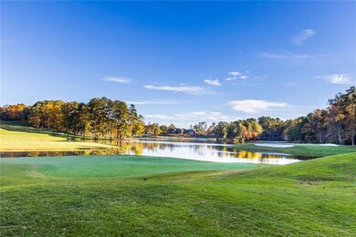 Surrounding community with a water view, golf course view, and a yard