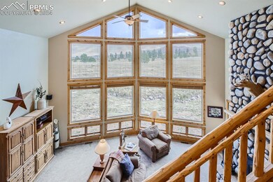 Living room with carpet floors, ceiling fan, lofte
