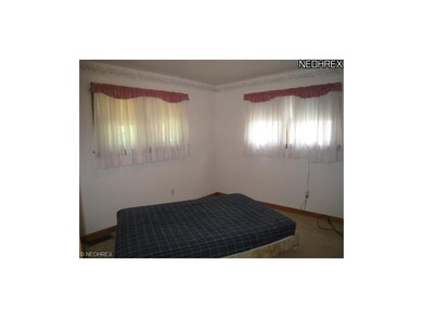 Bedroom 2 on 1st floor with hardwood floors undern