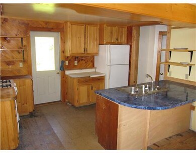 Kitchen. Back door leads to yard and...