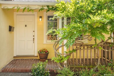 1310 Josephine front porch framed in wisteria.