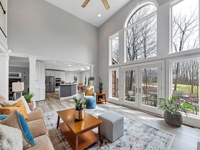 Foyer to open living room and the wall of windows 