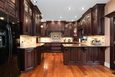 There is no telling what you will cook up in this dream kitchen. Picture shows an abundance of detailed wood cabinets