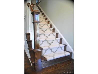 Hardwood Floors  showing finished Stairs w/Carpet Runner