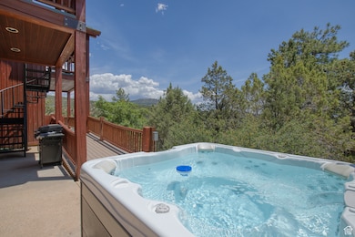View of pool featuring stairs, grilling area, a hot tub, and a wooden deck