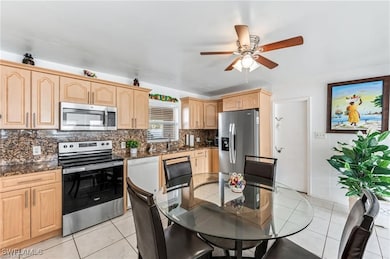 Kitchen with stainless steel appliances, light bro