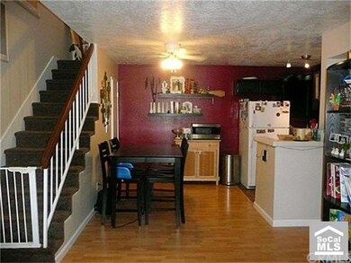 View of dining area and stairway up to the spaciou