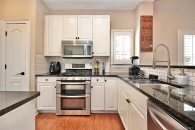 Upgraded kitchen with granite, subway tile backspl