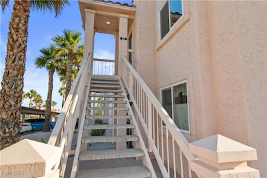 View of stairway to front door entry