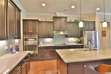 Beautiful gourmet kitchen with self closing drawer slide, built in garbage/recycle cabinet.  Walk to DR through double butlers pantry