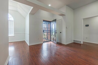 Foyer with dark wood-type flooring and a healthy a