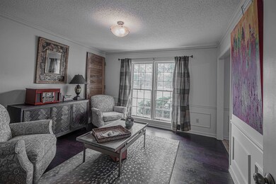 Living area with dark hardwood / wood-style floors