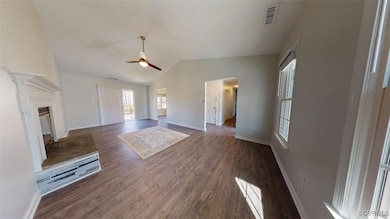 Unfurnished living room with ceiling fan, lofted c