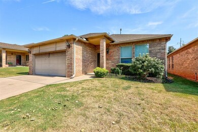 Ranch-style home featuring a garage and a front ya