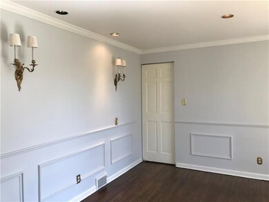 Dining room with wainscoting, electric sconces, re
