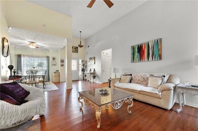 Living room with baseboards, a ceiling fan, and wo