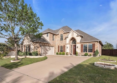 View of front of home featuring a garage and a front lawn