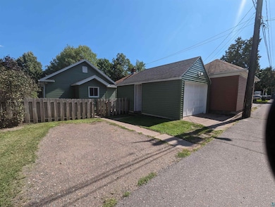 Ranch-style house featuring an outbuilding and a g