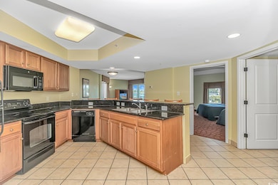 Kitchen featuring a sink, light tile patterned flo