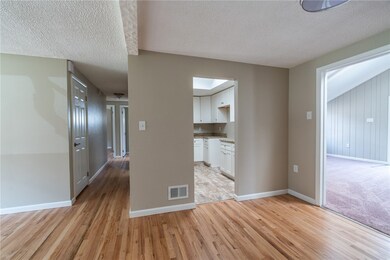 A view of the dining area, kitchen, hallway to the