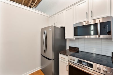 Kitchen featuring stainless steel appliances, back