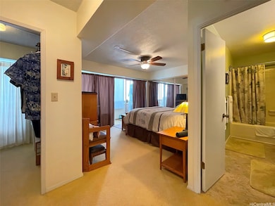 View into primary suite with walk-in closet to the