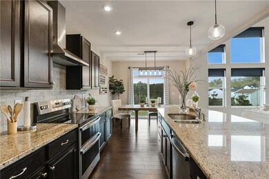 Kitchen with a sink, tasteful backsplash, applianc