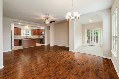 Unfurnished living room featuring a sink, arched 