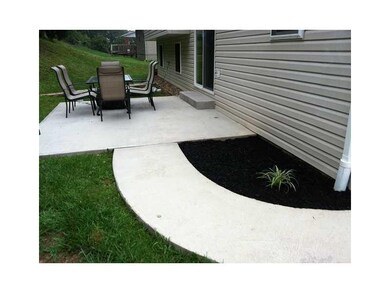 Exterior Back. Concrete patio invites friends & fa