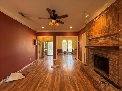 Unfurnished living room featuring baseboards, a br