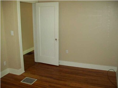 Main bedroom on main level with hardwood flooring 