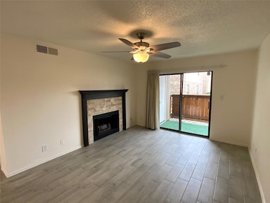 Unfurnished living room featuring ceiling fan, a t