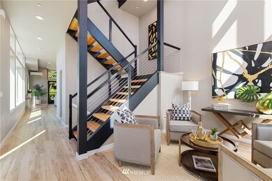 Enter into this truly stunning light-filled space with 20' ceilings and a huge WOW factor! Note the maple LVP floors throughout the entire home and the custom stainless steel and metal stair rails. (Note all photos are of Model Unit 6)