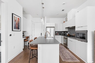 Kitchen with a sink, a breakfast bar area, dark c