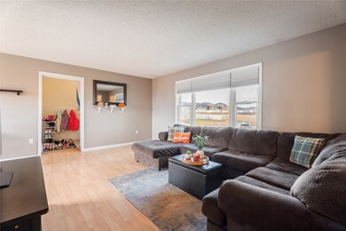 Living room with a textured ceiling and light wood finished floors