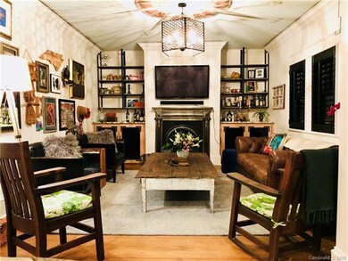 Living room with draft tap built in kegorater, antique steel mantle, plantation shutters