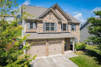 View of front of house with a garage, brick siding, concrete driveway, and a shingled roof