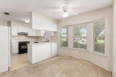 Kitchen featuring white cabinetry, stove, sink, wh
