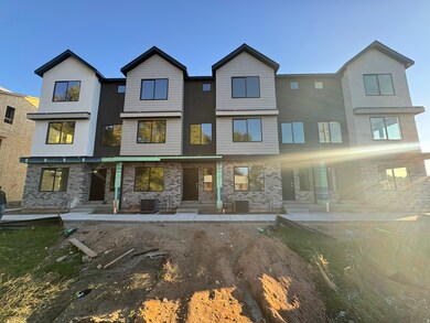 Modern home featuring a patio, brick siding, and stucco siding