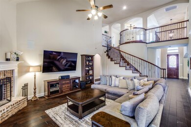 Juliet balcony overlooks living room with vaulted ceilings