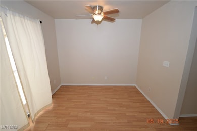 Unfurnished room featuring ceiling fan, light wood