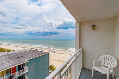 Balcony featuring a beach view and a water view