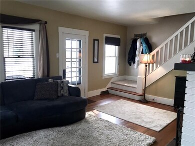 Five windows and a glass door give the living room