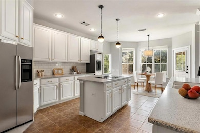 A look at the stainless steel appliances, built-in microwave over oven, and the sun-drenched breakfast area. *virtually staged