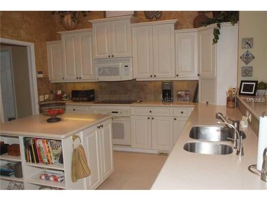 Kitchen - This cheerful, roomy kitchen is loaded with upgrades and is a very appealing be. It opens to the family room for great entertaining convenience and beautiful views of the water.
