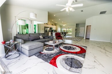 Living room featuring lofted ceiling and ceiling f