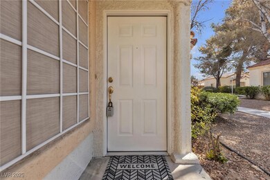 Entrance to property with stucco siding