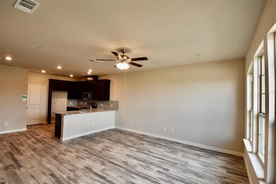 Kitchen with ceiling fan, light wood-type flooring, kitchen peninsula, and decorative backsplash