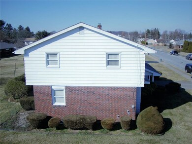 Elevated view  of side showing manicured shrubs.